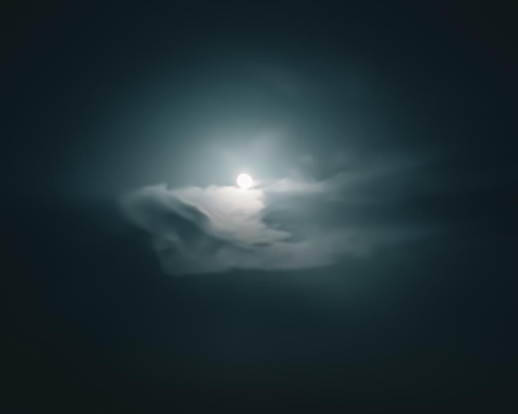 Photo of the moon 'sleeping' inside the clouds in a hot summer night in Venice